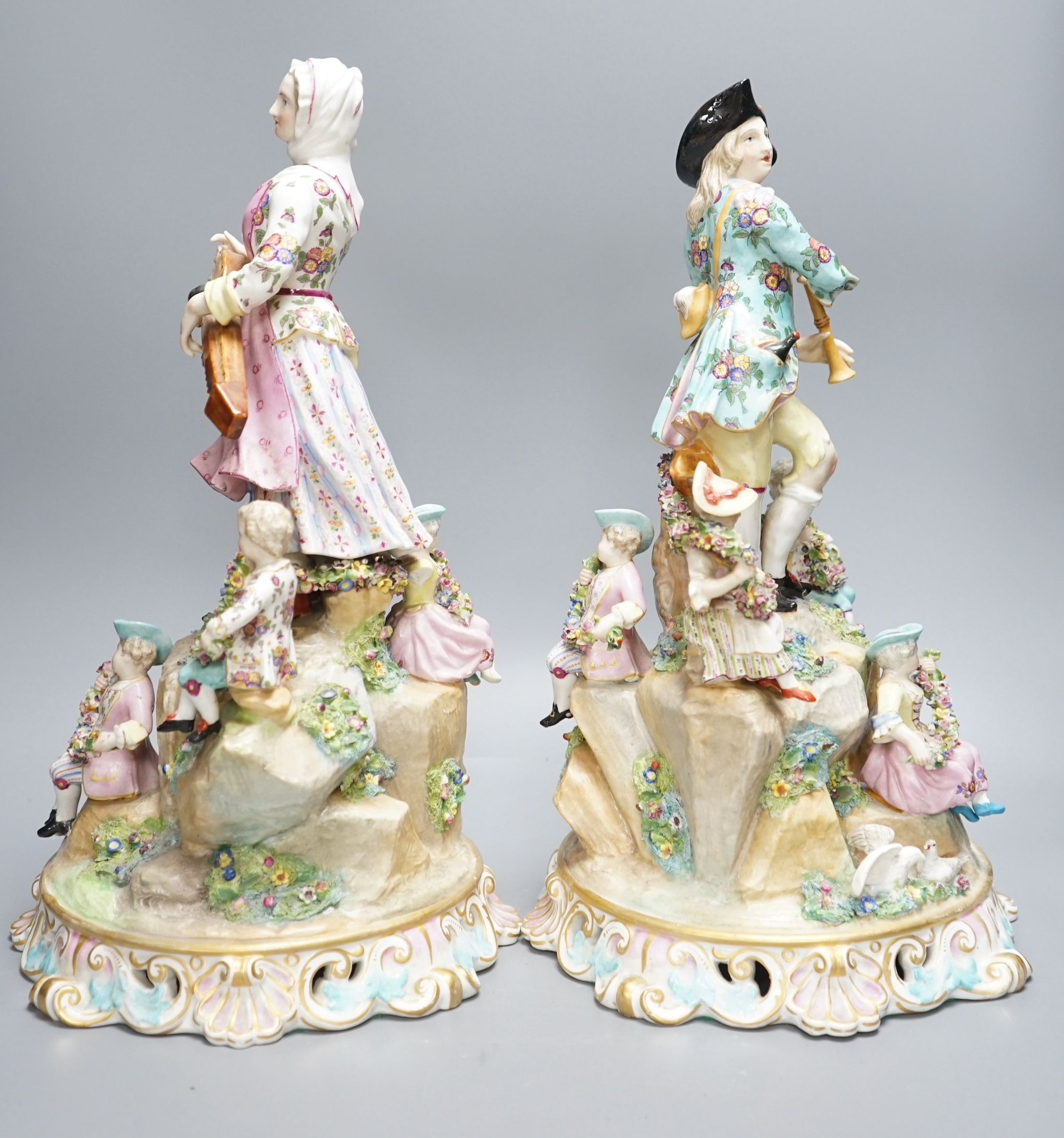 A pair of Meissen style porcelain musician figure groups, 42cms high